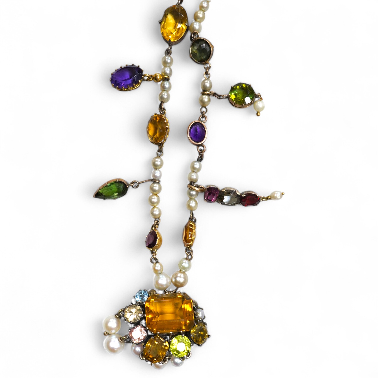 An Arts & Crafts gem-set and pearl necklace, circa 1900, composite, set with variously cut stones including citrine, amethyst, peridot, tourmaline and zircon, and pearls, length 42cm, pearls untested, Condition: good, ty